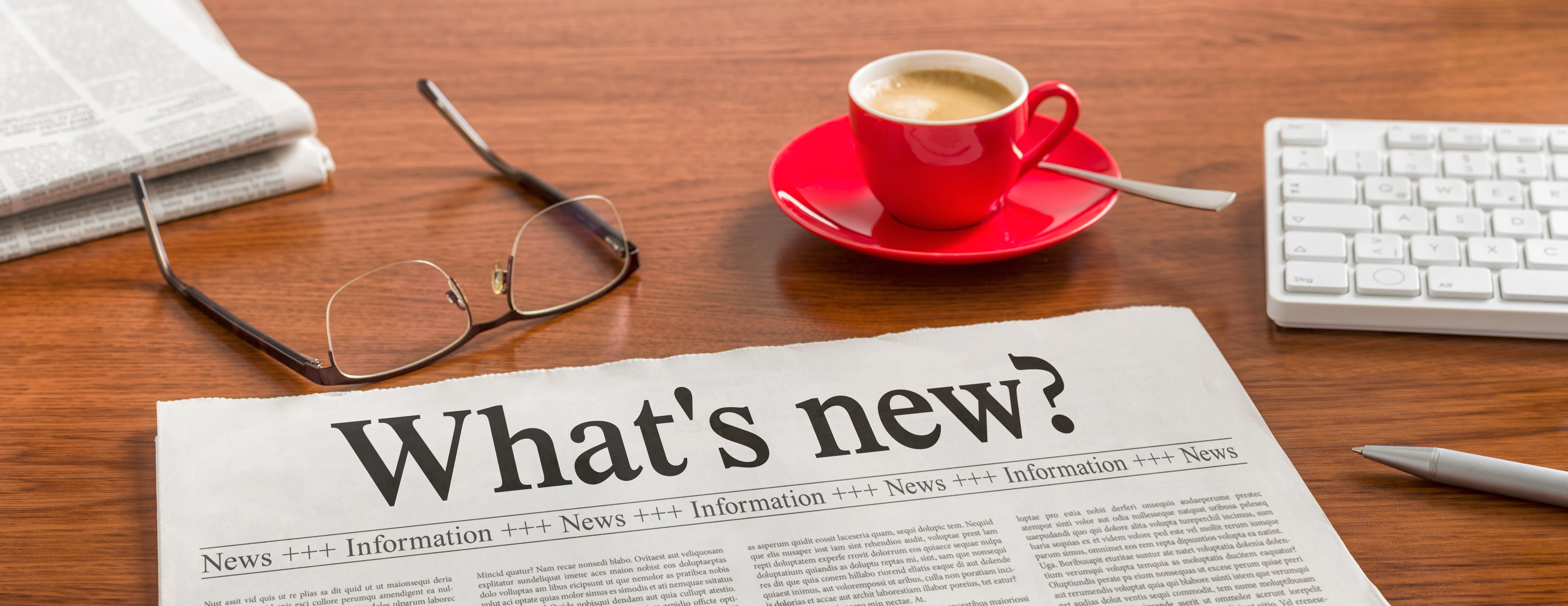 image of newspaper on desk with the title, "What's new?"
